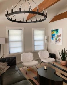 Modern living room in Escondido with two windows featuring custom sheer window shades that softly diffuse natural light.