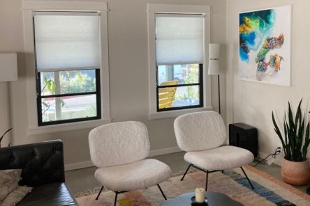 Bright and inviting Escondido living area with pull down window shades partially open, blending privacy and outdoor views.