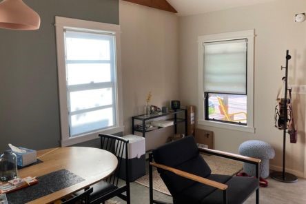 Dining nook in Escondido home showcasing custom high quality roller shades for windows, enhancing comfort and style.