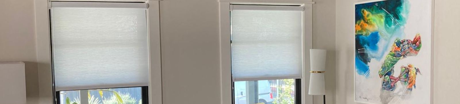 Modern living room in Escondido with two windows featuring custom sheer window shades that softly diffuse natural light.